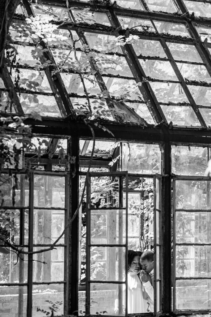 a Black couple poses in a greenhouse in Austin, TX