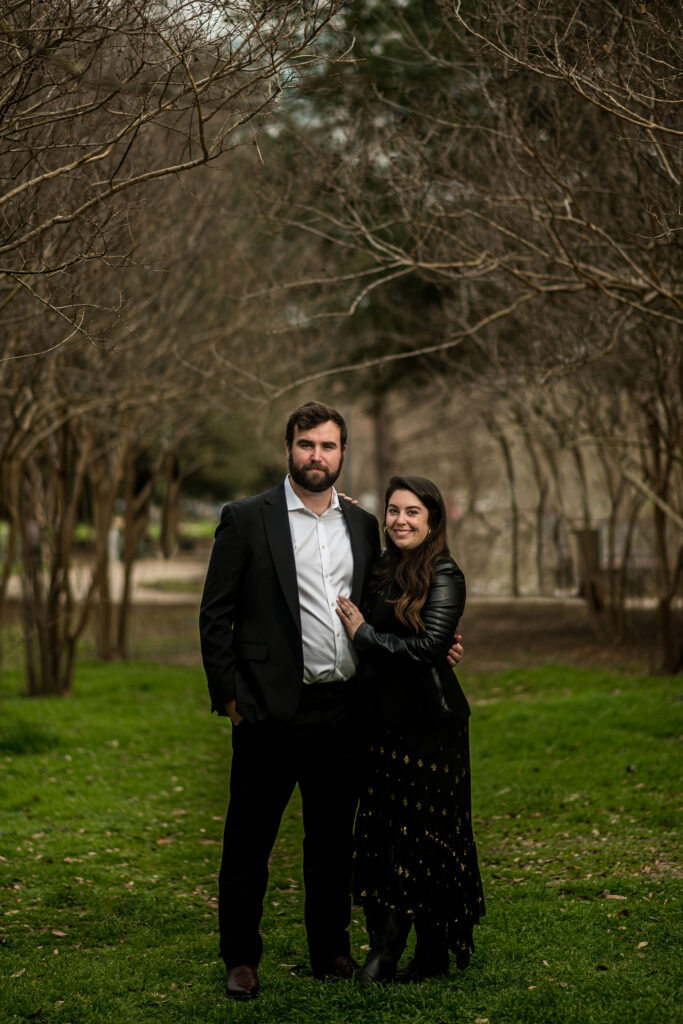 a couple poses for a dark and moody surprise proposal shoot in Austin