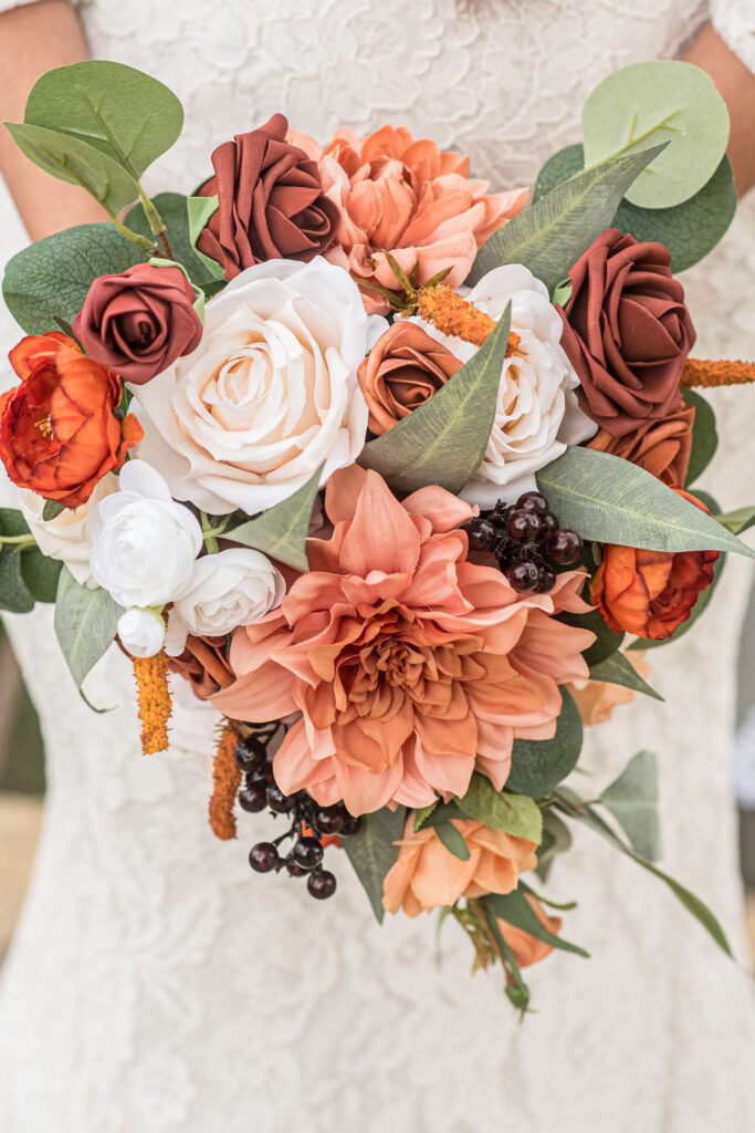 a wedding bouquet with shades of orange flowers