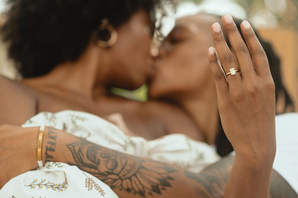 an LGBT couple poses for their surprise proposal engagement session