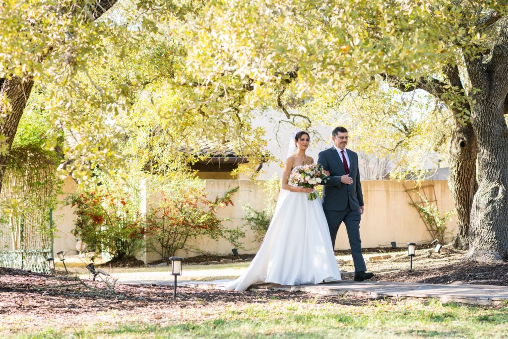 A bride walls down the aisle for her wedding at The Ma Maison