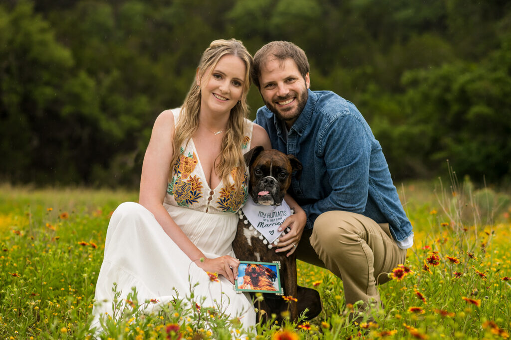 A couple poses with their dog for their engagement photography session in Austin, TX