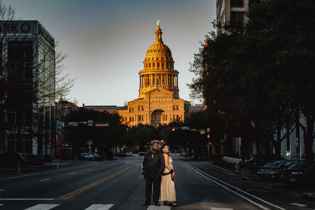 A couple poses for their engagement photography session in Downtown Austin by the Capitol